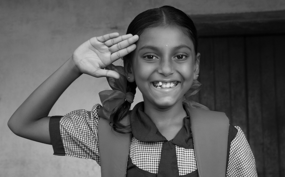 An Indian girl in school saluting