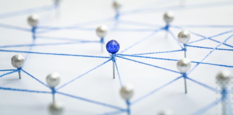 Visual representation of backlinks with pins connected by blue string, illustrating a network of interconnected web pages for SEO.